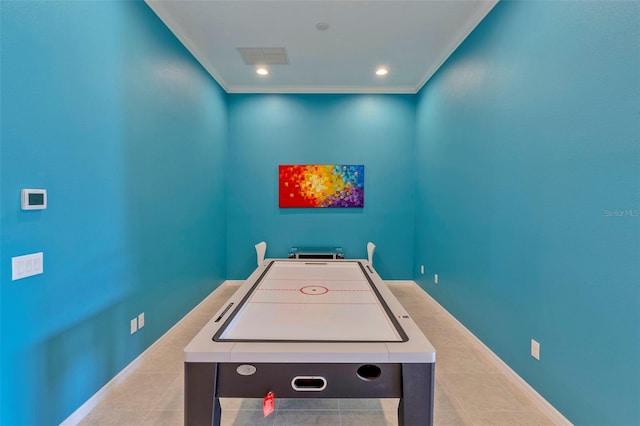 game room with ornamental molding and light tile patterned flooring