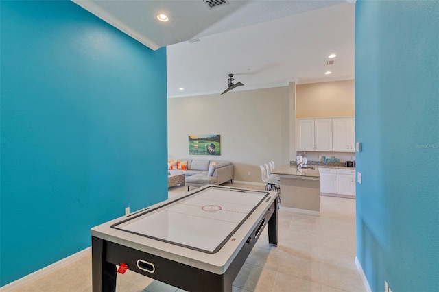 game room featuring crown molding and light tile patterned flooring