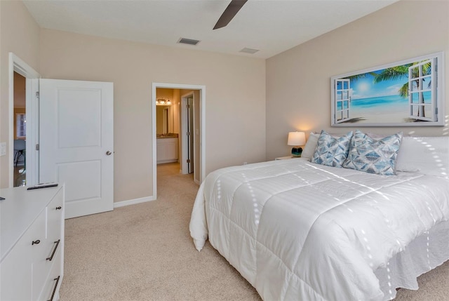 carpeted bedroom featuring ceiling fan and ensuite bathroom