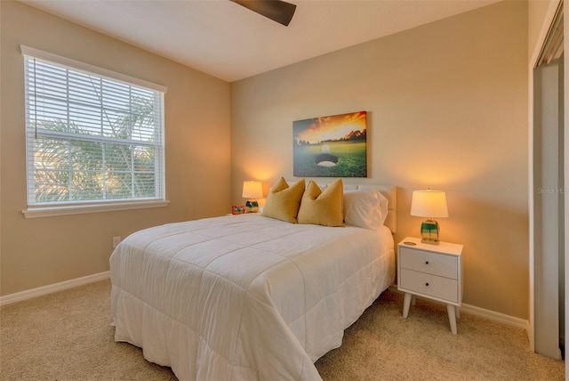 bedroom featuring ceiling fan and light colored carpet