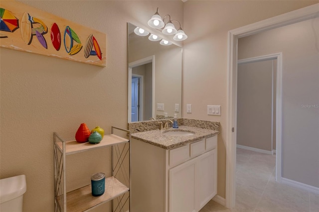 bathroom with vanity, toilet, and tile patterned flooring