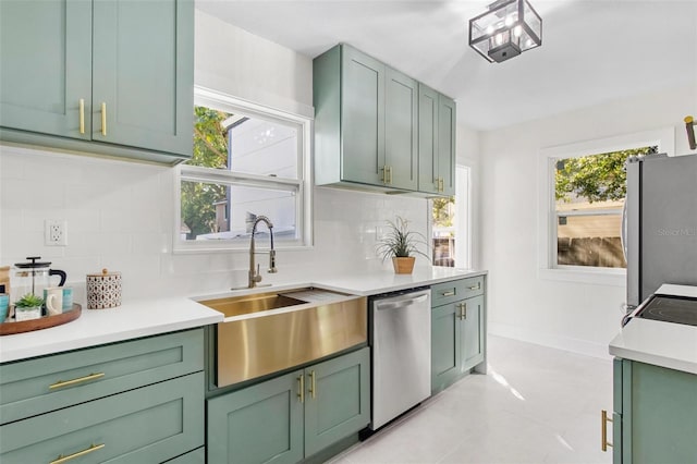 kitchen featuring appliances with stainless steel finishes, tasteful backsplash, a wealth of natural light, and sink