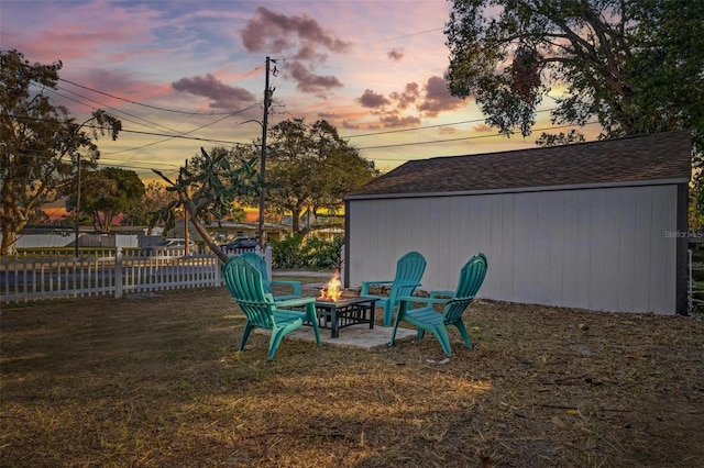 yard at dusk featuring a fire pit