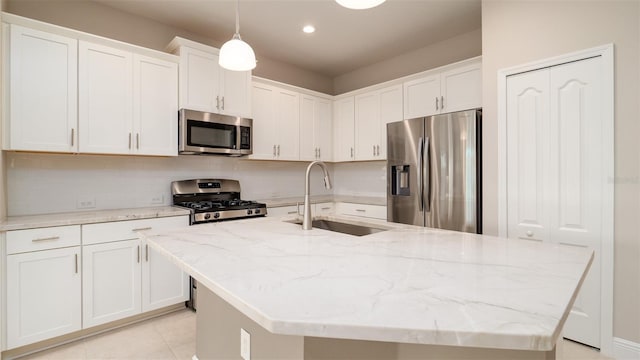 4326 Tamarind Pl, Bradenton, FL 34203 - kitchen with stainless steel appliances, a sink, an island with sink, white cabinetry, and recessed lighting