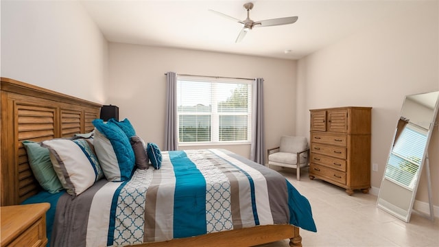 4326 Tamarind Pl, Bradenton, FL 34203 - bedroom with light tile patterned floors, a ceiling fan, and baseboards