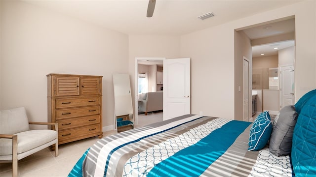 bedroom with ceiling fan, light tile patterned floors, and connected bathroom