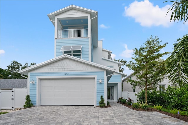 view of front of property featuring a garage and a balcony