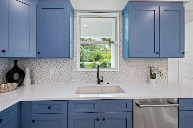 kitchen with decorative backsplash, stainless steel dishwasher, blue cabinetry, and sink