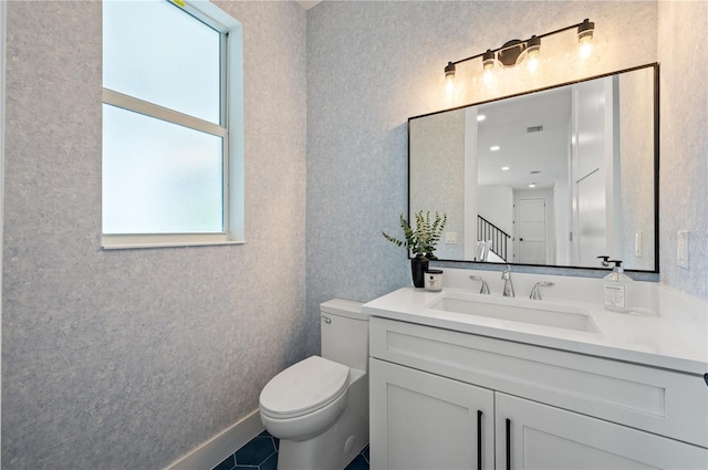 bathroom featuring tile patterned flooring, vanity, and toilet