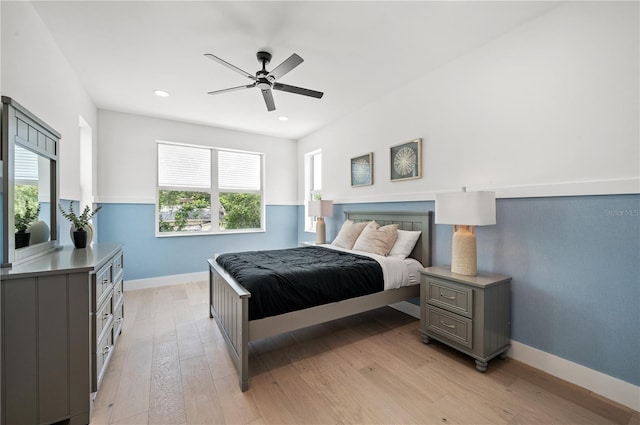 bedroom featuring multiple windows, ceiling fan, and light wood-type flooring