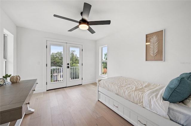 bedroom with access to exterior, ceiling fan, french doors, and light hardwood / wood-style flooring