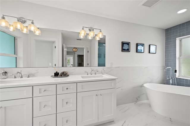 bathroom featuring shower with separate bathtub, vanity, and tile walls