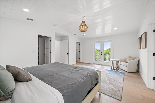 bedroom featuring light wood-type flooring, access to outside, and french doors