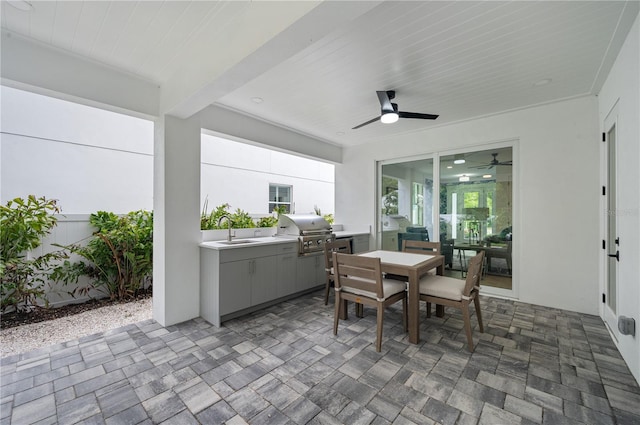 view of patio / terrace with ceiling fan, a grill, sink, and an outdoor kitchen