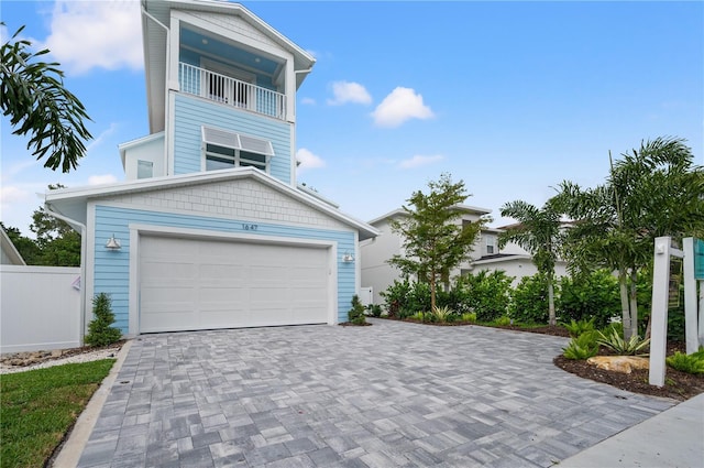 view of front of home featuring a balcony and a garage