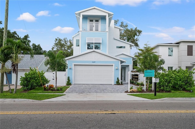 view of front of property with a garage and a balcony