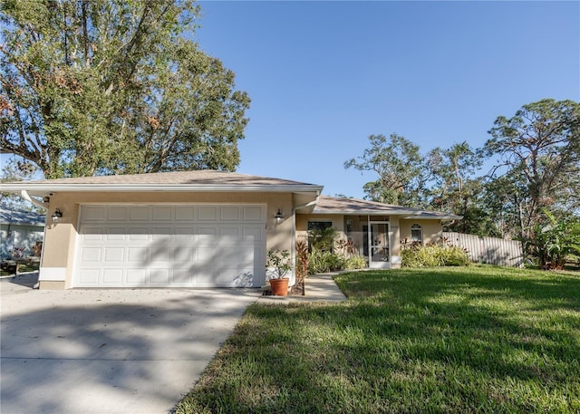 view of front of property with a garage and a front lawn