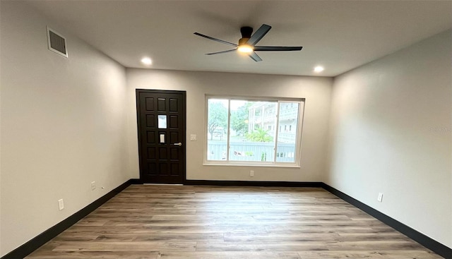 entrance foyer with ceiling fan and light hardwood / wood-style flooring