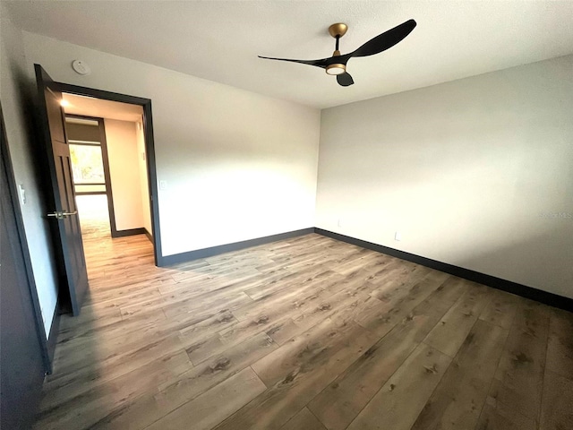 unfurnished room featuring hardwood / wood-style flooring and ceiling fan