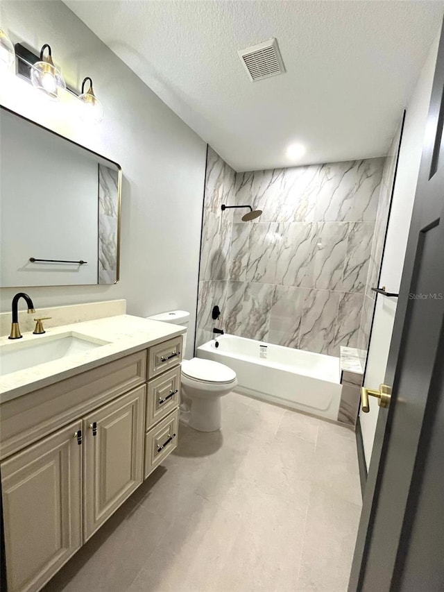 full bathroom with a textured ceiling, vanity, tiled shower / bath combo, and toilet