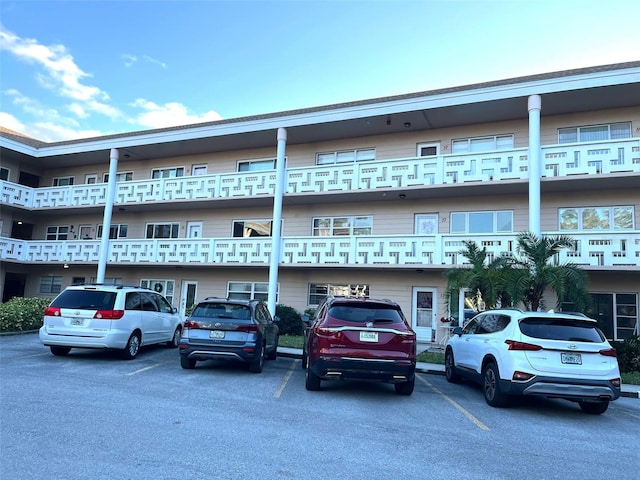 view of building exterior featuring uncovered parking