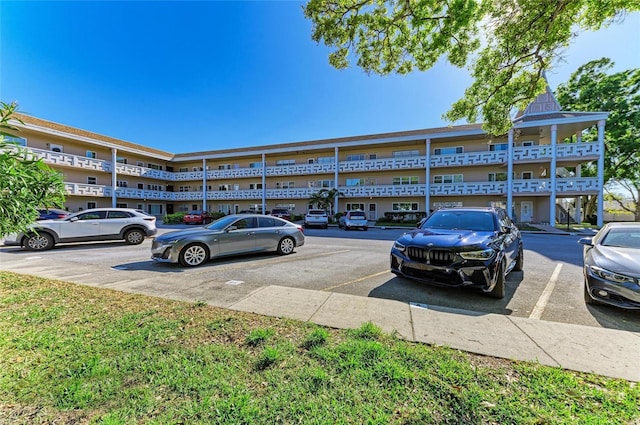 view of building exterior featuring uncovered parking