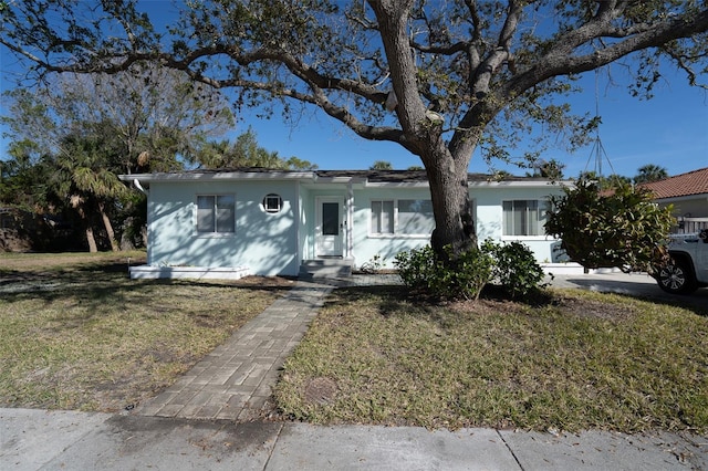 ranch-style home with a front lawn