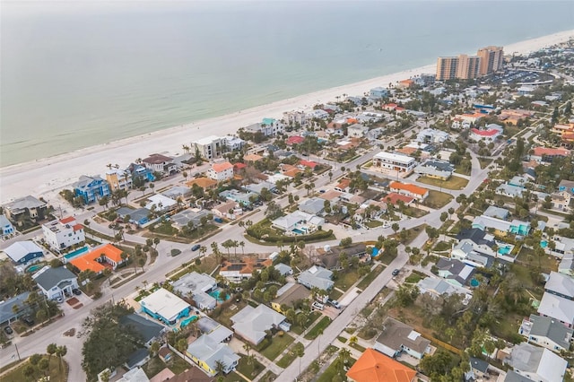 drone / aerial view featuring a water view and a beach view