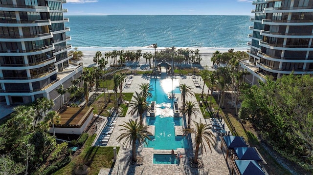 bird's eye view with a water view and a beach view