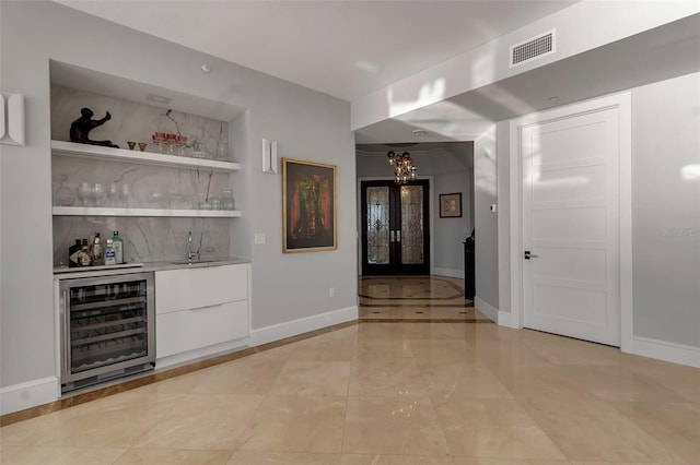 415 L Ambiance Dr Unit A801, Longboat Key, FL 34228 - indoor bar with beverage cooler, a chandelier, light marble finish flooring, and inlaid floor details