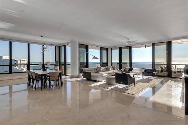 415 L Ambiance Dr Unit A801, Longboat Key, FL 34228 - living room with expansive windows, a chandelier, and a ceiling fan