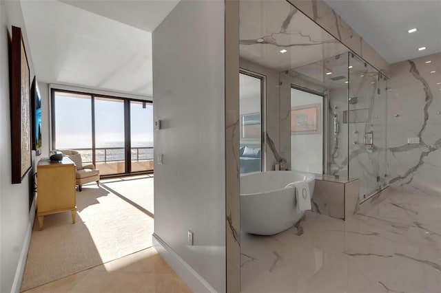 415 L Ambiance Dr Unit A801, Longboat Key, FL 34228 - bathroom featuring a marble finish shower, a soaking tub, floor to ceiling windows, recessed lighting, and a water view