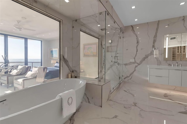 bathroom with vanity, a water view, separate shower and tub, and ceiling fan