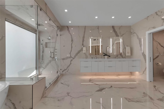 bathroom featuring vanity and shower with separate bathtub