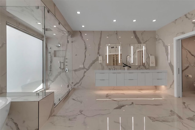 415 L Ambiance Dr Unit A801, Longboat Key, FL 34228 - bathroom featuring stone wall, marble tiled flooring, a marble finish shower, double vanity, and a freestanding bath