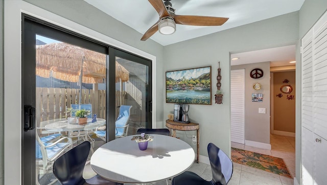 tiled dining area with ceiling fan