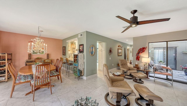 dining space with ceiling fan with notable chandelier and light tile patterned flooring