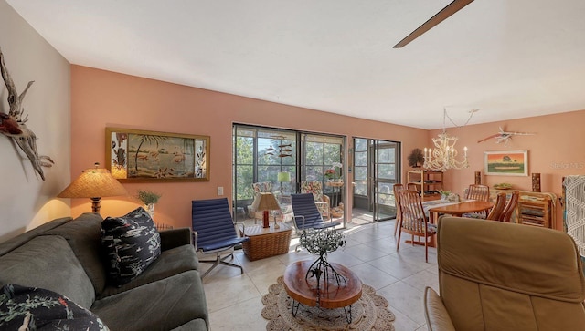 tiled living room with ceiling fan with notable chandelier