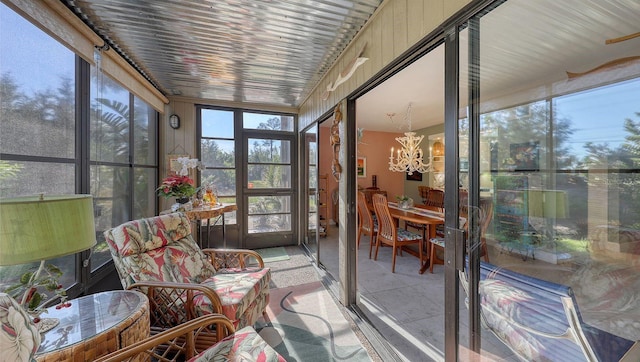 sunroom featuring a notable chandelier