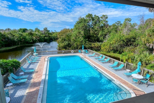 view of swimming pool with a water view