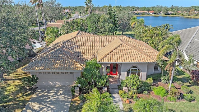 view of front facade featuring a garage and a water view