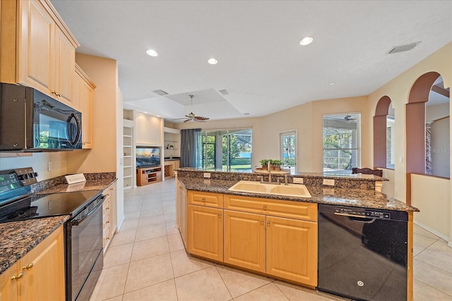 kitchen featuring black appliances, built in shelves, dark stone countertops, sink, and ceiling fan