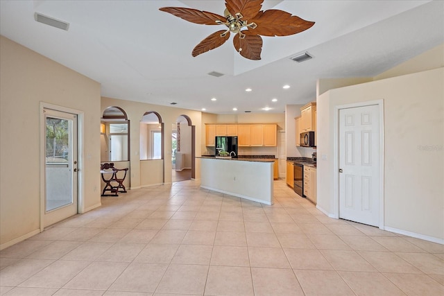 kitchen featuring black appliances, light tile patterned floors, ceiling fan, and a center island