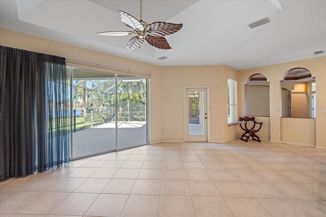 tiled spare room featuring ceiling fan