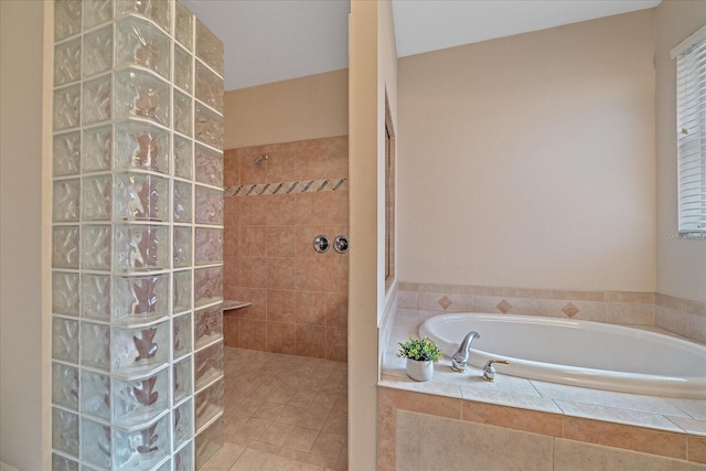 bathroom with shower with separate bathtub and tile patterned floors