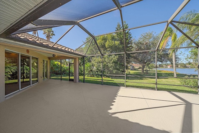 unfurnished sunroom featuring a water view