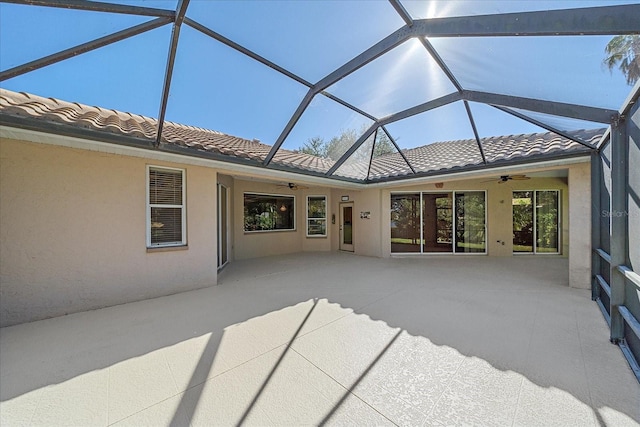 exterior space with glass enclosure and a patio