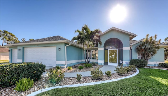 42 Marker Rd, Rotonda West, FL 33947 - ranch-style house with stucco siding, a garage, and a front yard