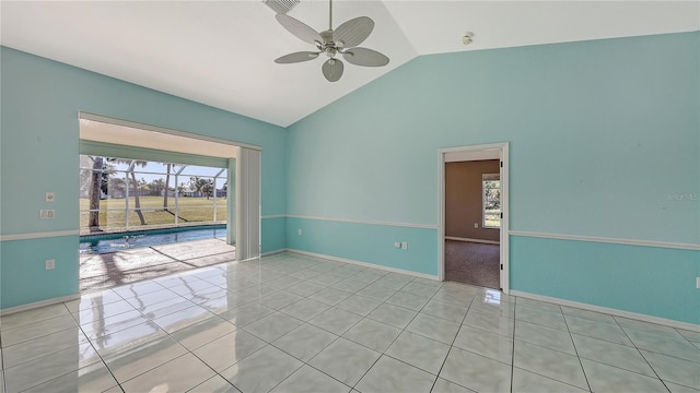 tiled spare room with ceiling fan and high vaulted ceiling