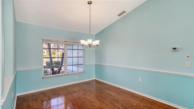 unfurnished room featuring wood-type flooring, high vaulted ceiling, and a chandelier